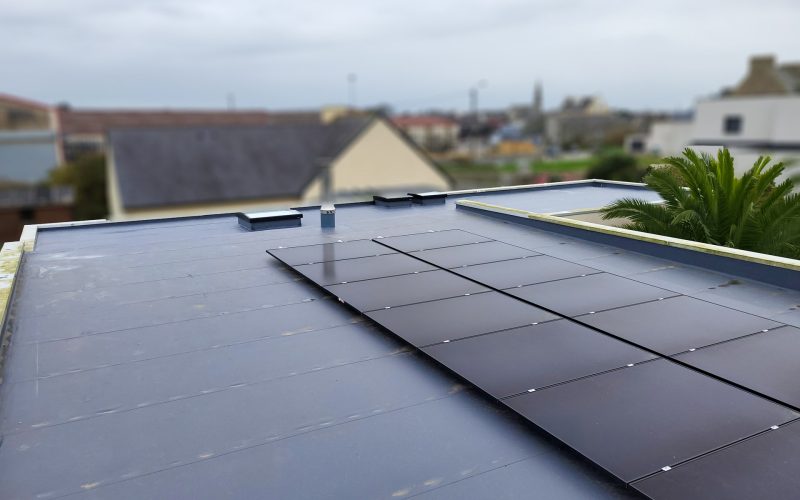 Panneaux solaires photovoltaïques sur un toit plat en membrane à Lannilis dans le Finistère.